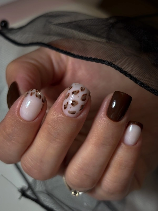 Apperçu des mains d'une cliente avec une pose en nail art léopard